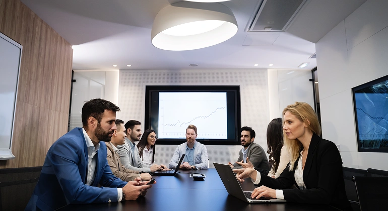 Business meeting with presentation and laptops.